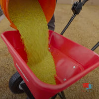 Prodiamine .38% Pre-Emergent Herbicide with Fertilizer 0-0-7 pouring prodiamine into spreader