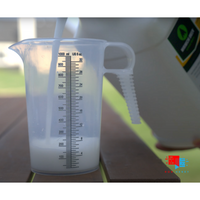 Mirimichi Green Pest Control - Non-Toxic Pest Control Pouring Mirimichi Green Pest Control into measuring cup