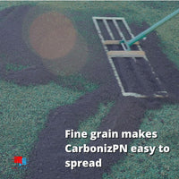 CarbonizPN™ - Top Dressing Soil Enhancer with Biochar Working CarbonizPN into lawn with leveling rake
